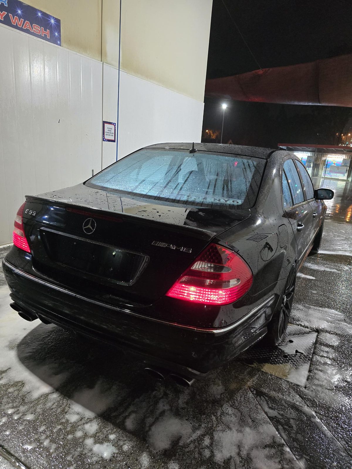 Black Mercedes-AMG being washed at night